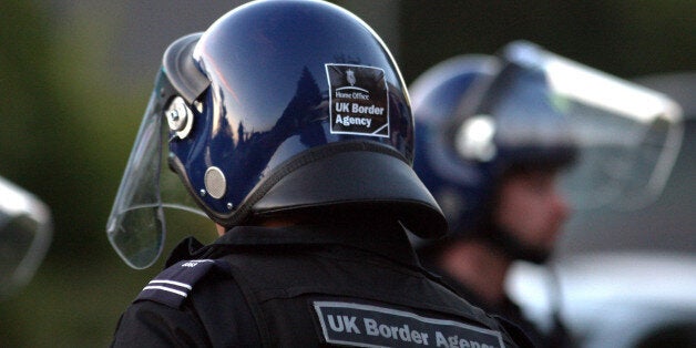 Officers from the UK Border Agency during a search for illegal workers at Honeytop Foods in Dunstable, Bedfordshire.