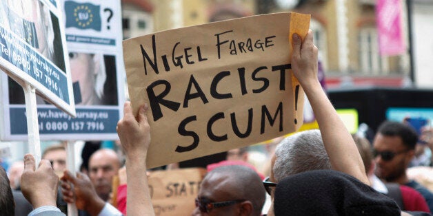 CROYDON, ENGLAND - MAY 20: A member of public waves an anti-UKIP banner outside the Whitgift Centre on May 20, 2014 in Croydon, England. Mr Farage was due to attend the UKIP mini carnival in Croydon High Street but pulled out at the last minute. Designed to show diversity within his party organisers said his no show was due to fears for his safety. (Photo by Dan Dennison/Getty Images)