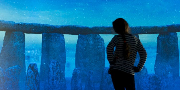 Embargoed to 0001 Tuesday December 17. A young visitor to the World Heritage Site of Stonehenge near Salisbury in Wiltshire experiences a virtual tour of the stones in the new visitor centre.