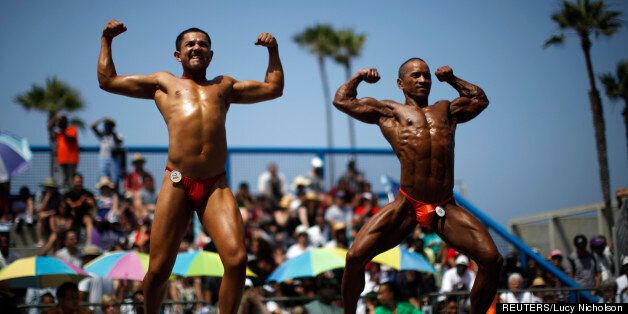 Men and women compete in the Muscle Beach Independence Day bodybuilding contest on Venice Beach in Los Angeles, California, July 4, 2013. (Credit: REUTERS/Lucy Nicholson)