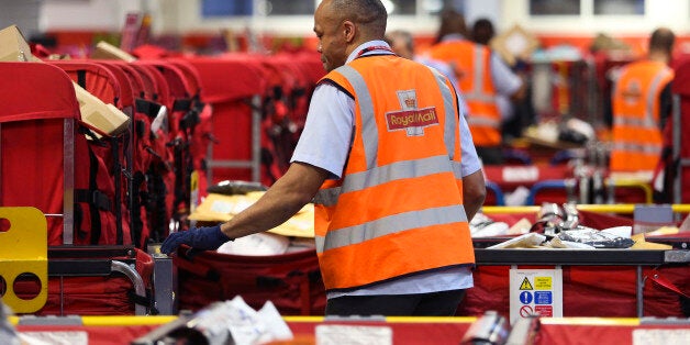 A Royal Mail Plc employee sorts parcels into red delivery destination trolleys at the company's Mount Pleasant postal sorting office in London, U.K., on Tuesday, Feb. 11, 2014. Royal Mail, the U.K. postal service that sold shares in an initial public offering last year, said like-for-like sales gained 2 percent in the first nine months of the year boosted by parcel deliveries. Photographer: Chris Ratcliffe/Bloomberg via Getty Images