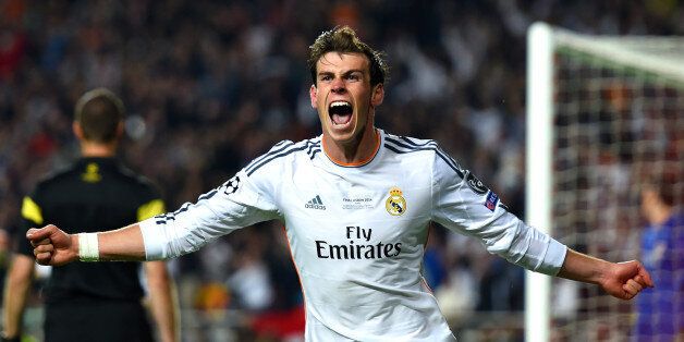 LISBON, PORTUGAL - MAY 24: Gareth Bale of Real Madrid celebrates scoring their second goal in extra time during the UEFA Champions League Final between Real Madrid and Atletico de Madrid at Estadio da Luz on May 24, 2014 in Lisbon, Portugal. (Photo by Shaun Botterill/Getty Images)