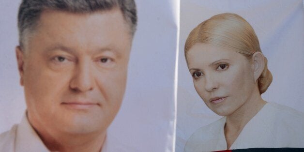 Placards depecting presidential candidates Yulia Tymoshenko (R) and Petro Poroshenko (L) are pictured in the western Ukrainian city of Lviv on May 21, 2014. Ukraine's glamorous but polarising ex-premier Yulia Tymoshenko was triumphantly released from prison during the pro-Western uprising in Kiev but is now a longshot in Sunday's presidential ballot due to mistrust of the corruption-stained old guard. AFP PHOTO/ YURKO DYACHYSHYN (Photo credit should read YURIY DYACHYSHYN/AFP/Getty Images)