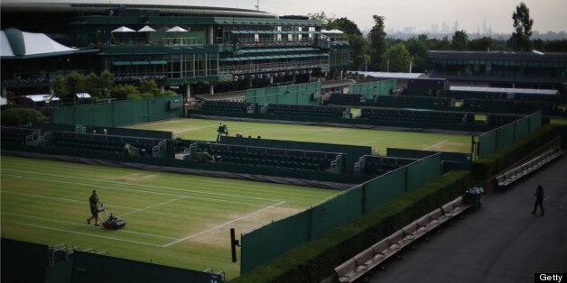 LONDON, ENGLAND - JULY 05: A member of the ground staff cuts the grass on court 14 before the start of play on day eleven of the Wimbledon Lawn Tennis Championships at the All England Lawn Tennis and Croquet Club on July 5, 2013 in London, England. (Photo by Peter Macdiarmid/Getty Images)