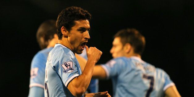 LONDON, ENGLAND - DECEMBER 21: Jesus Navas of Manchester City celebrates scoring their third goal during the Barclays Premier League match between Fulham and Manchester City at Craven Cottage on December 21, 2013 in London, England. (Photo by Clive Rose/Getty Images)
