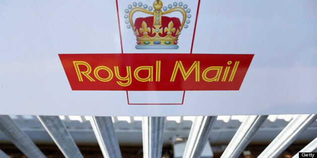 A logo sits on a sign outside Royal Mail Group Ltd.'s postal sorting office in Romford, U.K., on Wednesday, July 10, 2013. The U.K. government will sell a majority stake in Royal Mail Group Ltd., the 360-year-old state postal service, through an initial public offering before the end of March, Business Secretary Vince Cable said. Photographer: Chris Ratcliffe/Bloomberg via Getty Images