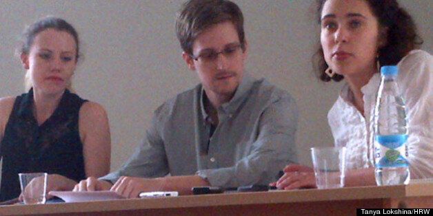 The first picture of Edward Snowden since he fled Hong Kong, with WikiLeaks lawyer Sarah Harrison on his right, and a translator on his left
