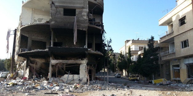 A picture taken on November 29, 2013 shows destruction in the predominantly Christian village of Deir Attiyeh where pro-government forces have driven out rebel fighters during recent battles in Syria's Qalamoun region. The Syrian army has already captured the towns of Qara and Deir Attiyeh, as the regime seeks to encircle the rebels in the Qalamoun region north of Damascus and sever opposition supply lines across the nearby border with Lebanon. AFP PHOTO/ALI MALEK (Photo credit should rea