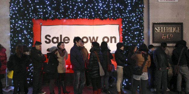 Shoppers queue outside Selfridge department store during the early hours of Boxing Day in central London, on December 26, 2011, in search of a bargain on the first day of the post Christmas Sales. London Underground drivers on Monday walked out in a row over pay, threatening disruption for shoppers at the start of the post-Christmas sales and football fans hoping to catch a festive fixture. AFP PHOTO / JUSTIN TALLIS (Photo credit should read JUSTIN TALLIS/AFP/Getty Images)