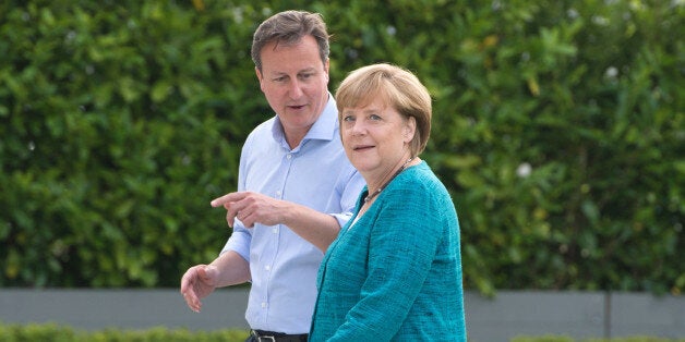 British Prime Minister David Cameron (L) greets Germany's Chancellor Angela Merkel (R) during the official arrrivals for the start of the G8 Summit in at the Lough Erne resort near Enniskillen in Northern Ireland on June 17, 2013. The conflict in Syria was set to dominate the G8 summit starting in Northern Ireland on Monday, with Western leaders upping pressure on Russia to back away from its support for President Bashar al-Assad. AFP PHOTO / BERTRAND LANGLOIS (Photo credit should read BERTRAND LANGLOIS/AFP/Getty Images)