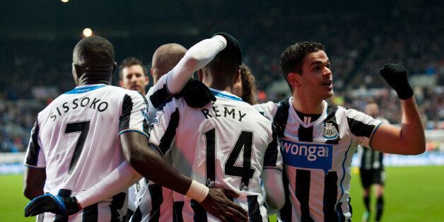 NEWCASTLE, ENGLAND - DECEMBER 26: Newcastle United players Hatem Ben Arfa (R) and Moussa Sissoko (L) celebrate with Loic Remy (C) who scored the second goal during the Barclays Premier League match between Newcastle United and Stoke City at St. James' Park on December 26, 2013, in Newcastle upon Tyne England. (Photo by Serena Taylor/Newcastle United via Getty Images)