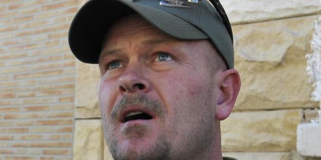 Samuel Joseph Wurzelbacher, or 'Joe the Plumber', looks at a building hit by a rocket launched by Gaza Strip militants in the coastal Israeli city of Ashkelon on January 12, 2009. Joe the Plumberï¿½, is morphing into 'Joe the War Correspondent'. He traveled to Israel to report for US conservative website pjtv.com, giving the perspective of ordinary Israelis on the conflict in Gaza. AFP PHOTO/DAVID BUIMOVITCH (Photo credit should read DAVID BUIMOVITCH/AFP/Getty Images)