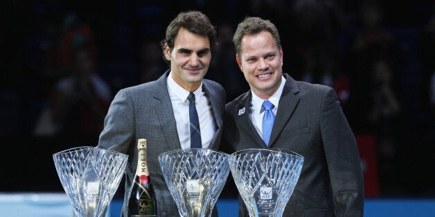 LONDON, ENGLAND - NOVEMBER 06: Roger Federer of Switzerland poses with the ATPWorldTour.com Fans' Favourite award, the Arthur Ashe Humanitarian of the Year award and the Stefan Edberg Sportsmanship award and Andre Silva, Barclays ATP World Tour Finals Tournament Director during day three of the Barclays ATP World Tour Finals at O2 Arena on November 6, 2013 in London, England. (Photo by Clive Brunskill/Getty Images)