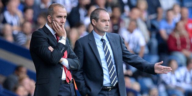 Sunderland manager Paolo Di Canio watches his team with West Bromwich Albion manager Steve Clarke (right) during the Barclays Premier League match at The Hawthorns, West Bromwich.