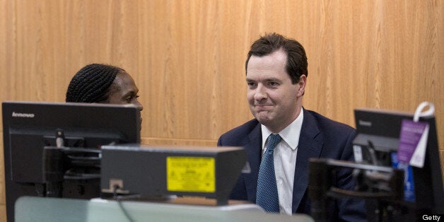 Britain's Chancellor of the Exchequer George Osborne (R) is shown a money counting machine by a member of staff in a branch of Lloyds bank in Central London on June 19, 2013. AFP PHOTO / JUSTIN TALLIS (Photo credit should read JUSTIN TALLIS/AFP/Getty Images)