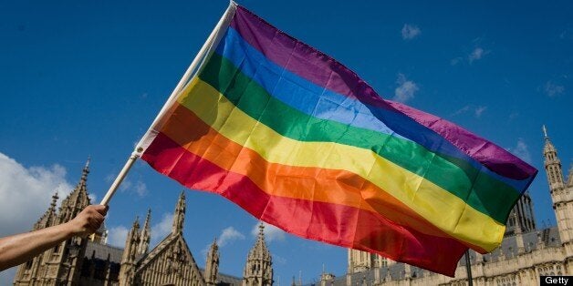 A protestor holds a rainbow flag outside the Houses of Parliament in central London on June 3, 2013, as protestors gather in support of same-sex marriage. A 'wrecking amendment' aimed at derailing the government's same-sex marriage bill, which was passed in the Commons despite the opposition of 133 Tory MPs, is being debated in the House of Lords. AFP PHOTO/Leon Neal (Photo credit should read LEON NEAL/AFP/Getty Images)