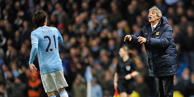 MANCHESTER, ENGLAND - DECEMBER 28: Manchester City Manager Manuel Pellegrini issues orders to David Silva of Manchester City during the Barclays Premier League match between Manchester City and Crystal Palace at the Etihad Stadium on December 28, 2013 in Manchester, England. (Photo by Clint Hughes/Getty Images)