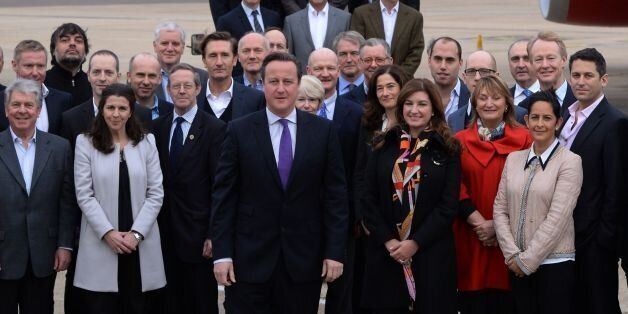 Prime Minister David Cameron (centre front), at Heathrow Airport, prior to heading to Beijing , China, poses with the largest British trade delegation ever to visit the far eastern country for a three day trade visit.
