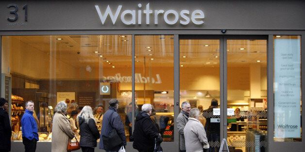 Customers queue outside the first Waitrose convenience store, which opened today on Trinity Square in Nottingham.