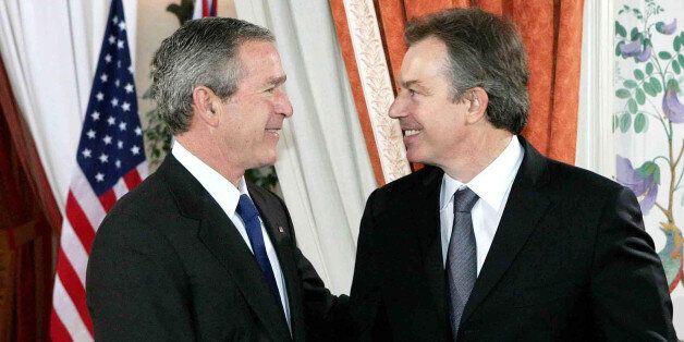 US President George Bush (left) shakes hand with British Prime Minister Tony Blair during a press conference at the US Ambassador's residence in Brussels.