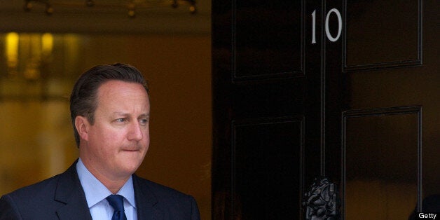 British Prime Minister David Cameron waits for the arrival of Emirati Crown Prince of Abu Dhabi Mohammed bin Zayed al-Nahyan ahead of a meeting at 10 Downing Street in central London on July 15, 2013. AFP PHOTO / ANDREW COWIE (Photo credit should read ANDREW COWIE/AFP/Getty Images)