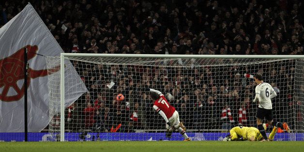 Arsenal's Czech midfielder Tomas Rosicky (L) celebrates scoring their second goal during the English FA cup third round football match between Arsenal and Tottenham Hotspur at the Emirates Stadium in London on January 4, 2014. AFP PHOTO/ADRIAN DENNISRESTRICTED TO EDITORIAL USE. No use with unauthorized audio, video, data, fixture lists, club/league logos or live services. Online in-match use limited to 45 images, no video emulation. No use in betting, games or single club/league/player publicat