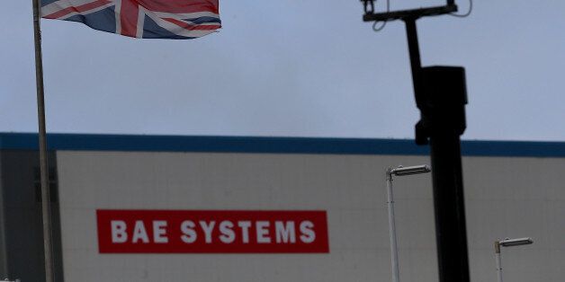 PORTSMOUTH, SCOTLAND - NOVEMBER 06: A Union Jack flag flies above the BAE systems yard at the HM Naval Base in Portsmouth dockyard following the announcement that the company will be cutting jobs on November 6, 2013 in Portsmouth, England. The cuts are being made following a decline in orders, with 1775 jobs going between the yards in Scotland and England with the end of shipbuilding altogether at the Portsmouth yard. (Photo by Matt Cardy/Getty Images)