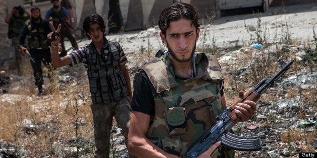 Syrian rebel fighters belonging to the 'Martyrs of Maaret al-Numan' battalion leave their position after a range of shootings on June 13, 2013 in the northwestern town of Maaret al-Numan in front of the army base of Wadi Deif, down in the valley. At least 93,000 people, including over 6,500 children, have been killed in Syria's civil war, the United Nations said on June 13, 2013, warning that the true death toll could be far higher. AFP PHOTO DANIEL LEAL-OLIVAS (Photo credit should read