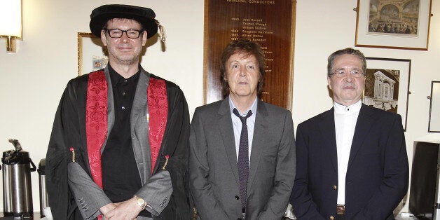 Sir Paul McCartney, co-founder of LIPA, presents an award to music producer Alan Moulder (left). He is one of seven luminaries from the arts and entertainment industry who were made Companions of the Liverpool Institute for Performing Arts, at the Institute's annual graduation ceremony.