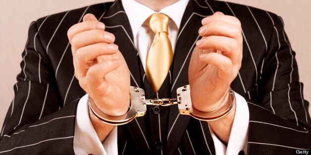 Banker in handcuffs.