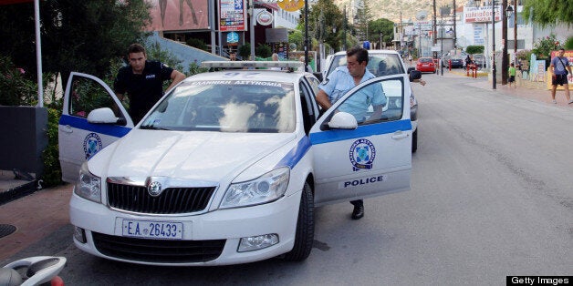 Police outside the bar where a British tourist was found stabbed to death