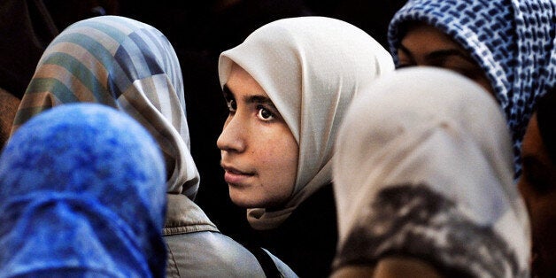 Women hold a protest outside the French Embassy in Edinburgh, to demonstrate against he French President Jacques Chirac's decision to push for a law banning the wearing of headscarves in schools. 12/04/2004: Schools in England and Wales must not follow the example of France and ban Muslim girls from wearing the hijab, or veil, in class, teachers were arguing Monday April 12 2004. The call came during debates about racism and the rise of the British National Party in some parts of the country at