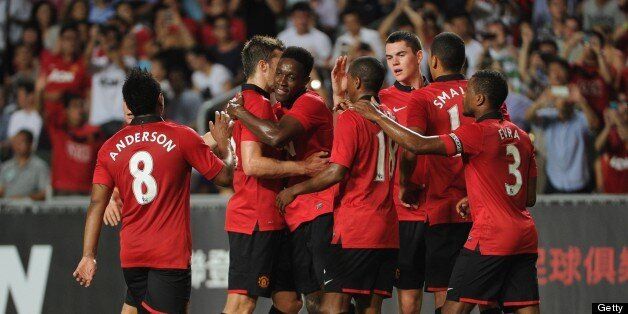 Manchester United players celebrate a goal against Kitchee during their football friendly match at Hong Kong stadium on July 29, 2013. AFP PHOTO / Dale de la Rey (Photo credit should read DALE de la REY/AFP/Getty Images)