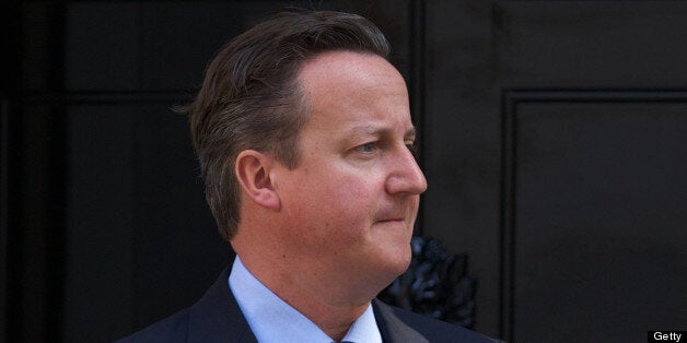 British Prime Minister David Cameron waits for the arrival of Emirati Crown Prince of Abu Dhabi Mohammed bin Zayed al-Nahyan ahead of a meeting at 10 Downing Street in central London on July 15, 2013. AFP PHOTO / ANDREW COWIE (Photo credit should read ANDREW COWIE/AFP/Getty Images)