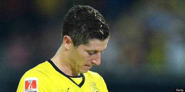 Dortmund's Polish striker Robert Lewandowski (L) holds the trophy after winning the German Supercup football match Borussia Dortmund vs Bayern Munich 4-2