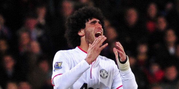 Manchester United's Belgian midfielder Marouane Fellaini reacts after missing a chance during the English Premier League football match between Crystal Palace and Manchester United at Selhurst Park in south London on February 22, 2014. AFP PHOTO / CARL COURTRESTRICTED TO EDITORIAL USE. No use with unauthorized audio, video, data, fixture lists, club/league logos or live services. Online in-match use limited to 45 images, no video emulation. No use in betting, games or single club/league/player p