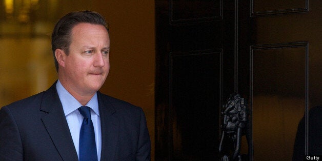 British Prime Minister David Cameron waits for the arrival of Emirati Crown Prince of Abu Dhabi Mohammed bin Zayed al-Nahyan ahead of a meeting at 10 Downing Street in central London on July 15, 2013. AFP PHOTO / ANDREW COWIE (Photo credit should read ANDREW COWIE/AFP/Getty Images)