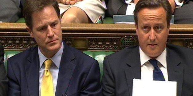 Deputy Prime Minister Nick Clegg and Prime Minister David Cameron listen as leader of the opposition Ed Miliband speaks during a debate on the Queen's Speech in the House of Commons, London.