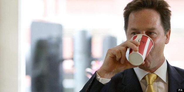 Deputy Prime Minister Nick Clegg drinks a coffee at the Olive Delicatessen in Manchester city centre.