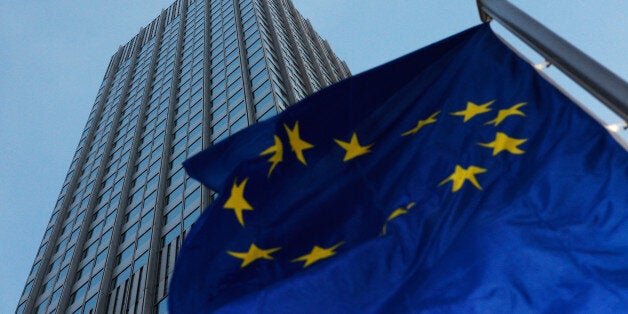 A European Union flag flies outside the headquarters of the European Central Bank (ECB) in Frankfurt, Germany, on Wednesday, Jan. 8, 2014. Mario Draghi, the ECB president, is convening the first rate-setting meeting of 2014 in Frankfurt today with a to-do list that includes supporting the recovery in the 18-nation currency bloc and carrying out a balance-sheet review of its largest lenders. Photographer: Ralph Orlowski/Bloomberg via Getty Images