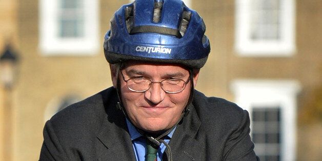 Former British minister Andrew Mitchell rides a bicycle as he leaves his home in London on November 26, 2013, shortly before prosecutors were set to reveal whether they will bring charges linked to the Plebgate row. Five police officers and three members of the public are currently on bail after they were arrested in the wake of a confrontation between the former chief whip and police guarding Downing Street. AFP PHOTO / BEN STANSALL (Photo credit should read BEN STANSALL/AFP/Getty Images