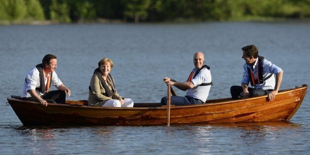 (L to R) British Prime Minister David Cameron, German Chancellor Angela Merkel, Swedish Prime minister Fredrik Reinfeldt and Dutch Prime Minister Mark Rutte talk in a boat near the summer residence of the Swedish Prime Minister in Harpsund 120km west of Stockholm on June 9, 2014. The Swedish Prime Minister will host German Chancellor Angela Merkel, British Prime Minister David Cameron and Dutch Prime Minister Mark Rutte for talks on the EU and the new European Parliament on June 9 to 10, 2014. A