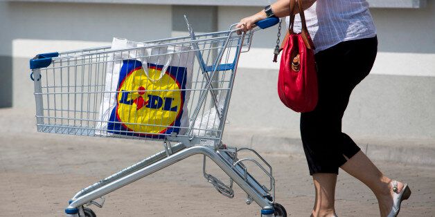 A customer uses a shopping cart to move her purchases across the parking lot outside a Lidl discount supermarket store, operated by Schwarz Group, in Prague, Czech Republic, on Thursday, June 13, 2013. Ahold and Tesco are tied as the Czech Republic's third-largest grocer by revenue behind Lidl discount store owner Schwarz Group and Rewe AV, which owns the Billa supermarkets, according to Krakow, Poland-based market researcher PMR. Photographer: Martin Divisek/Bloomberg via Getty Images