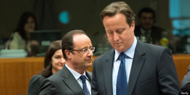 French President Francois Hollande (L) and British Prime Minister David Cameron arrive for a roundtable meeting at the EU headquarters on June 7, 2013 in Brussels, during European Union leaders summit. European Commission President Jose Manuel Barroso on Thursday announced a political deal on the EU's hotly contested 2014-2020 trillion-euro budget, hours before an EU summit mulls how to get millions of jobless youths back into the workplace. AFP PHOTO / BERTRAND LANGLOIS (Photo credit s