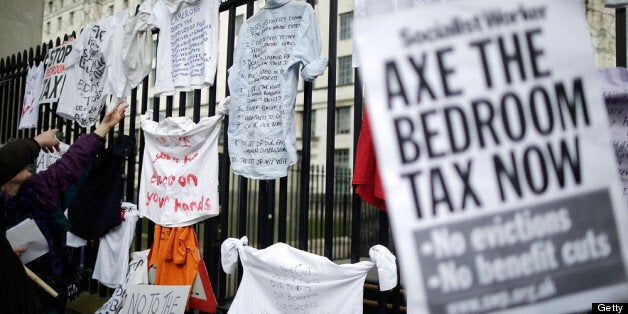 LONDON, ENGLAND - MARCH 30: Protestors hang signs on the gates as they demonstrate against the proposed 'bedroom tax' gather in Trafalgar Square before marching to Downing Street on March 30, 2013 in London, England. Welfare groups are protesting the government's plans to cut benefits where families have surpassed the number of rooms they require. (Photo by Matthew Lloyd/Getty Images)