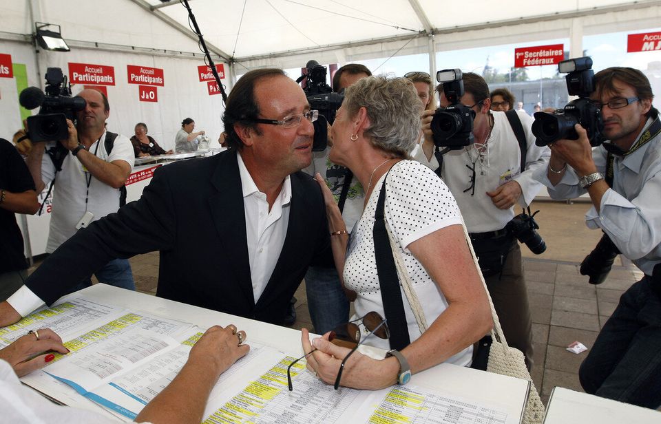 Although innocent, Hollande looks worried, perhaps aware his glistening face is no place for a woman's lips...