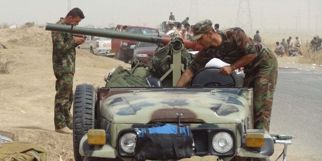 Kurdish Iraqi Peshmerga forces deploy their troops and armoured vehicles on the outskirts of the multi-ethnic city of Kirkuk, only 1 kilometre away from areas controlled by Sunni Muslim Jihadists from the Islamic State of Iraq and the Levant (ISIL) on the main road between Kirkuk, Mosul and Baiji in northern Iraq on June 12, 2014. With ISIL's Islamist fighters closing in on the Iraqi capital Baghdad, forces from Iraq's autonomous Kurdish region took control of disputed northern oil hub of Kirkuk to protect it from Islamist attack, officials said. AFP PHOTO/MARWAN IBRAHIM (Photo credit should read MARWAN IBRAHIM/AFP/Getty Images)