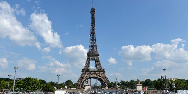 Children play in a fountain while people enjoy the sun in front of the Eiffel Tower on July 7, 2013 in Paris. AFP PHOTO / MIGUEL MEDINA (Photo credit should read MIGUEL MEDINA/AFP/Getty Images)