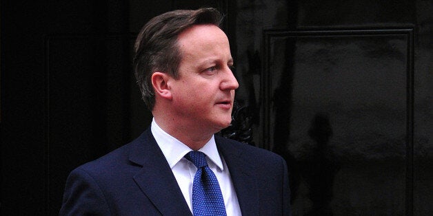 British Prime Minister David Cameron prepares to greet Cypriot President Nicos Anastasiades at Downing Street in central London on January 15, 2014. AFP PHOTO / CARL COURT (Photo credit should read CARL COURT/AFP/Getty Images)