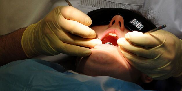 File photo dated 19/05/11 of a general view of dentist at work. Dentists' drills are set to become an unpleasant memory thanks to a tooth-rebuilding treatment that could be available in three years.